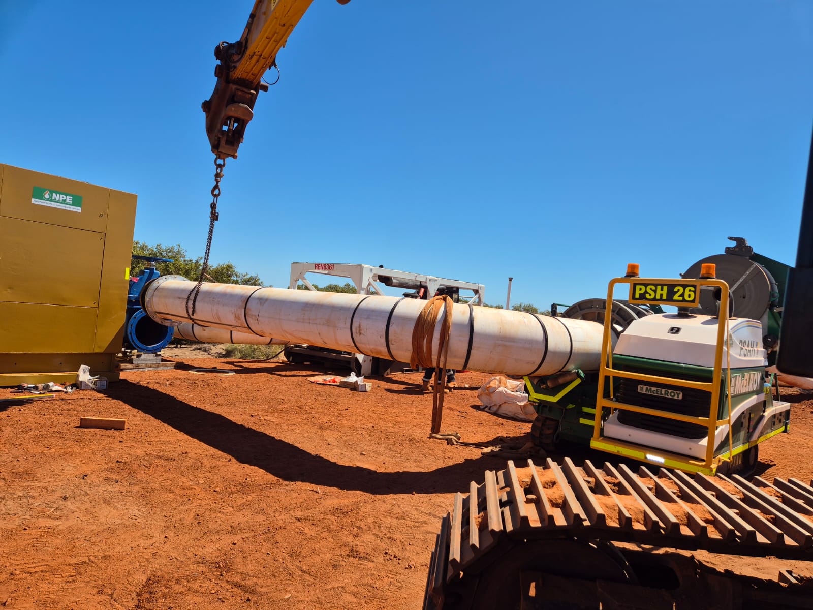 Loader lifting a large fabricated HDPE bend into the fusion machine