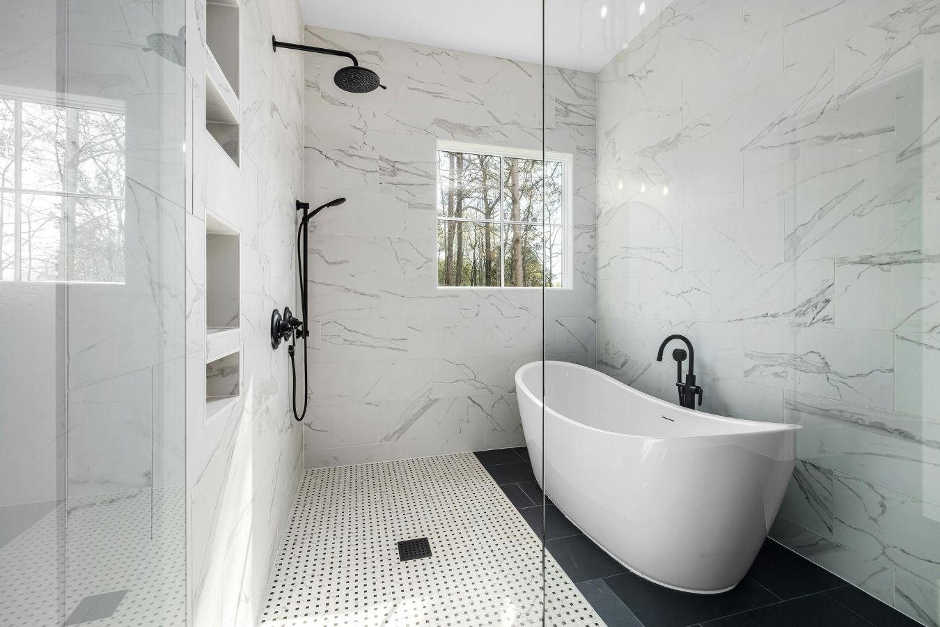 Walk-in shower with dark feature tiles and frameless glass screen