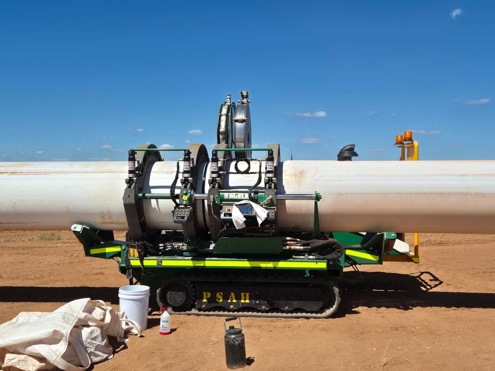 McElroy HDPE fusion machine set against a long large-diameter pipeline