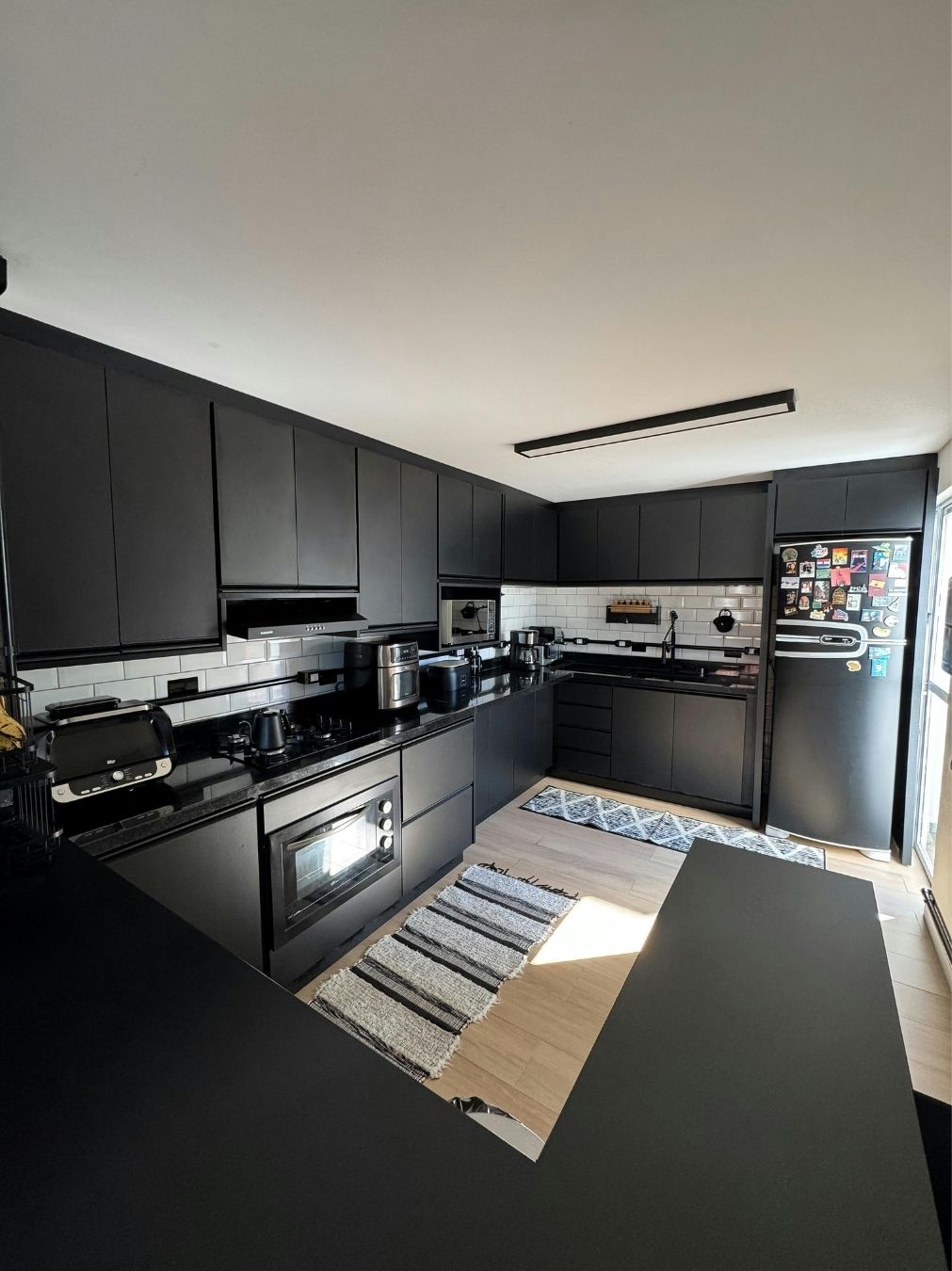 Marble waterfall island benchtop in a completed kitchen