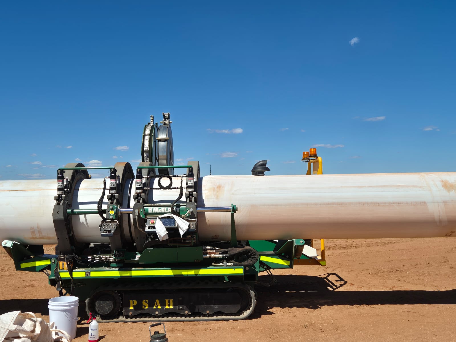 McElroy welding rig alongside a large-diameter HDPE pipeline